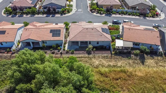 a aerial view of house with yard and outdoor seating