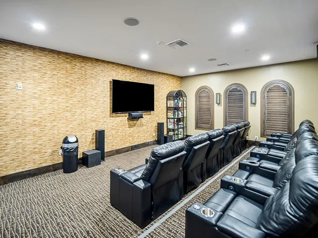 a view of a patio with lawn chairs under an umbrella