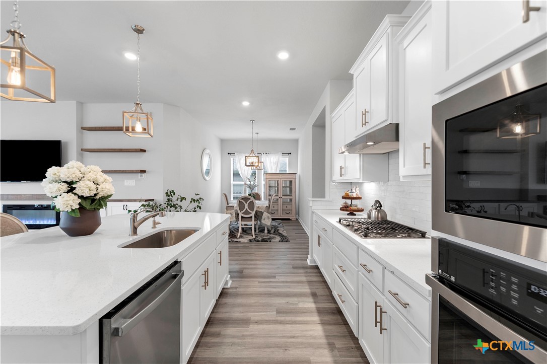 1616 Craftsman Road New Braunfels, TX 78132 - Photo 12 of 29 a kitchen with sink stove and cabinets