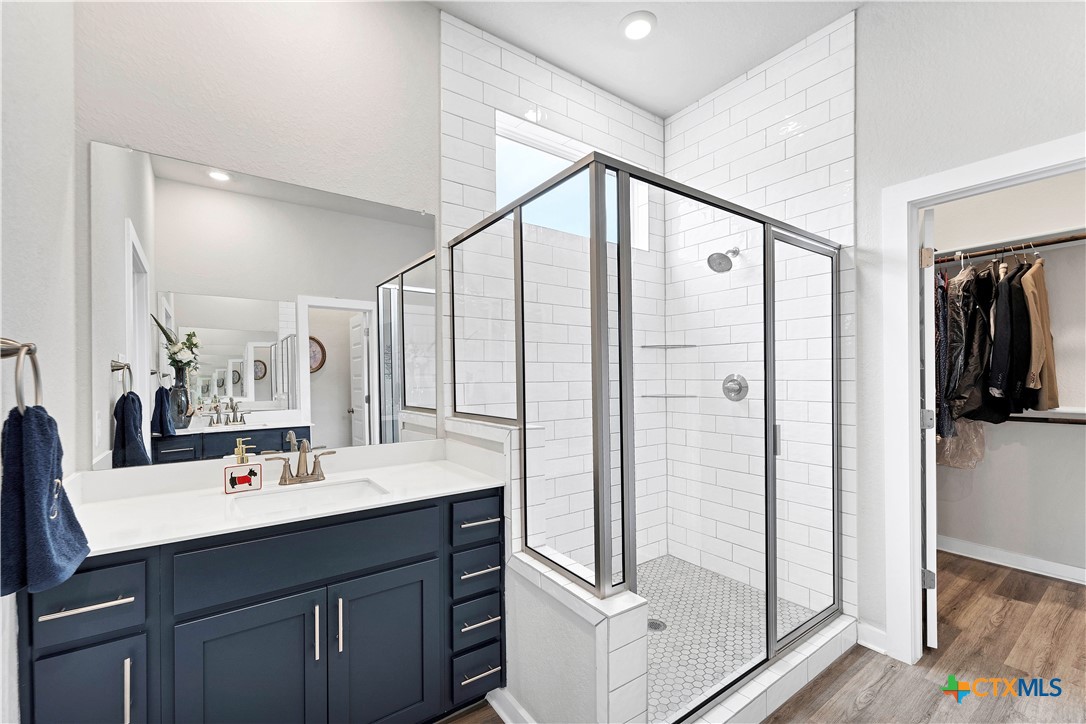 1616 Craftsman Road New Braunfels, TX 78132 - Photo 21 of 29 a bathroom with a double vanity sink mirror and shower