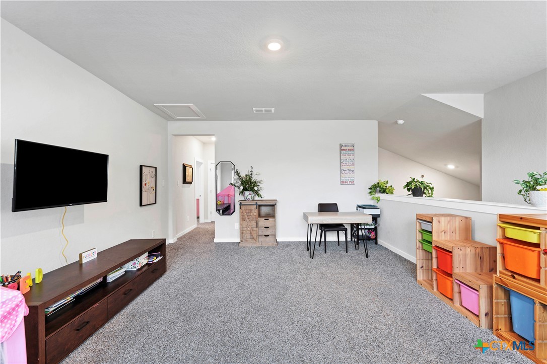 1616 Craftsman Road New Braunfels, TX 78132 - Photo 23 of 29 a living room with furniture and a flat screen tv