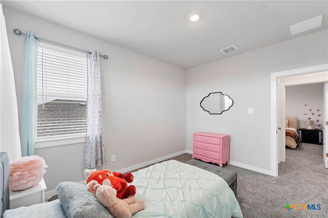 1616 Craftsman Road New Braunfels, TX 78132 - Photo 26 of 29 a bedroom with a bed and a window