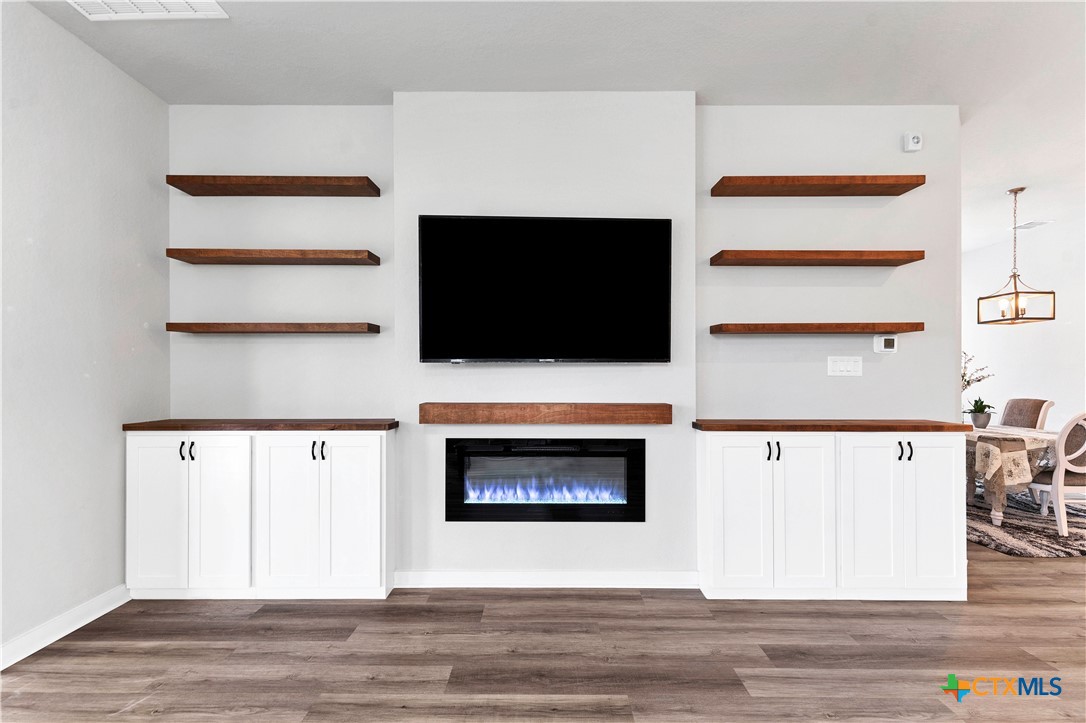 1616 Craftsman Road New Braunfels, TX 78132 - Photo 4 of 29 a view of living room with a flat screen tv and a couch with wooden floor