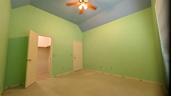 a view of a big room with closet and chandelier fan