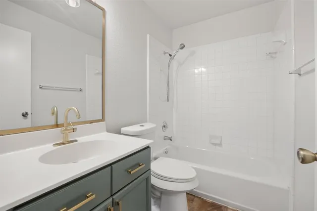 a bathroom with a sink toilet vanity and shower