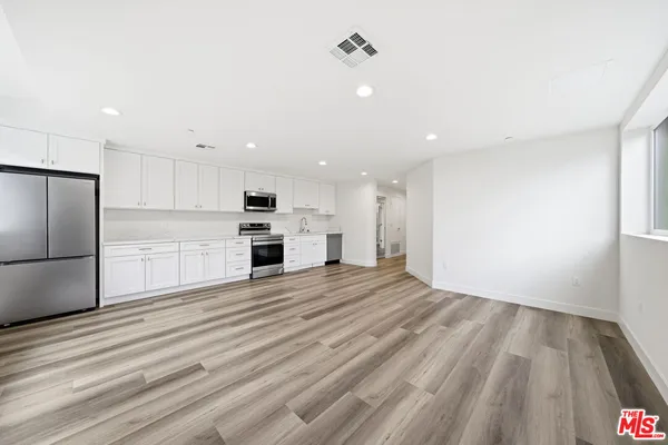 a view of kitchen view wooden floor and window