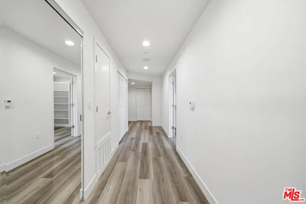 a view of a hallway with wooden floor
