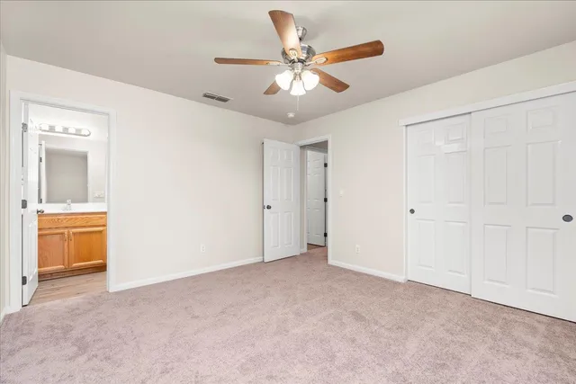 a bathroom with a granite countertop sink toilet and a mirror