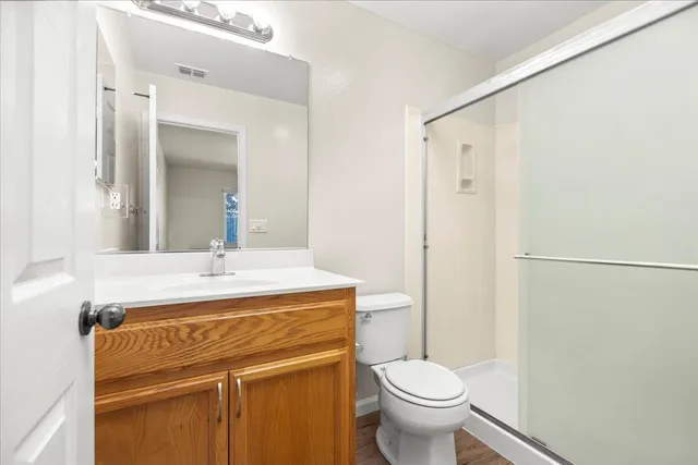 an empty room with a window and ceiling fan