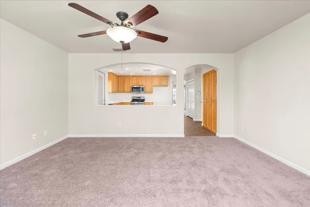 a kitchen with stainless steel appliances granite countertop a sink and wooden floor