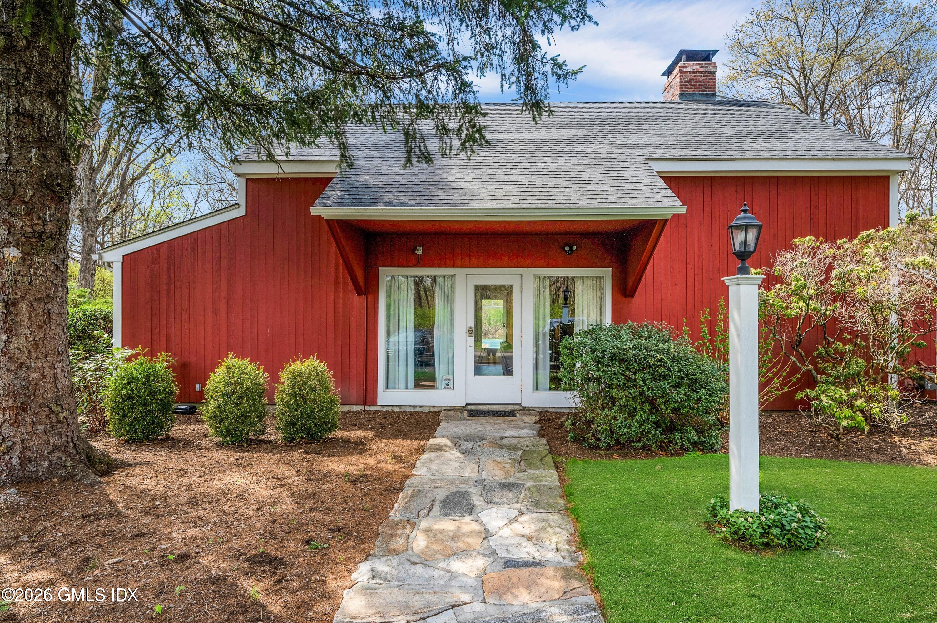 58 Stirrup Lane, Unit 58 Riverside, CT 06878 - Photo 17 of 23 a front view of a house with garden