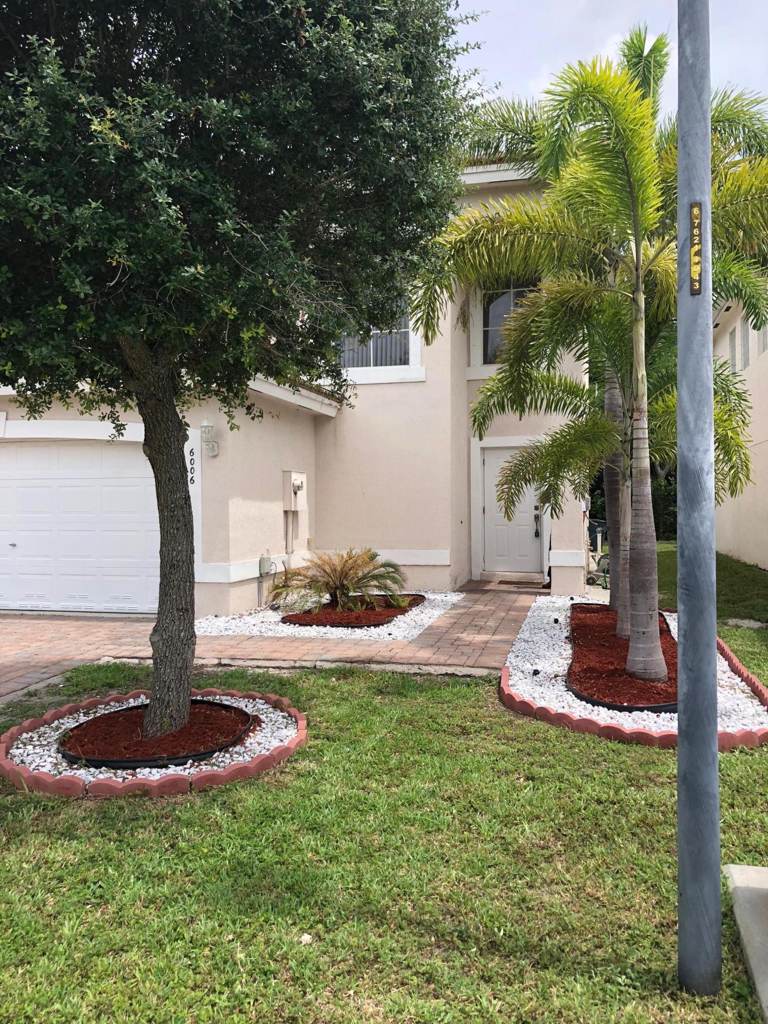 6006 Adriatic Way Greenacres, FL 33413 - Photo 2 of 33 front side of 6006 Adriatic