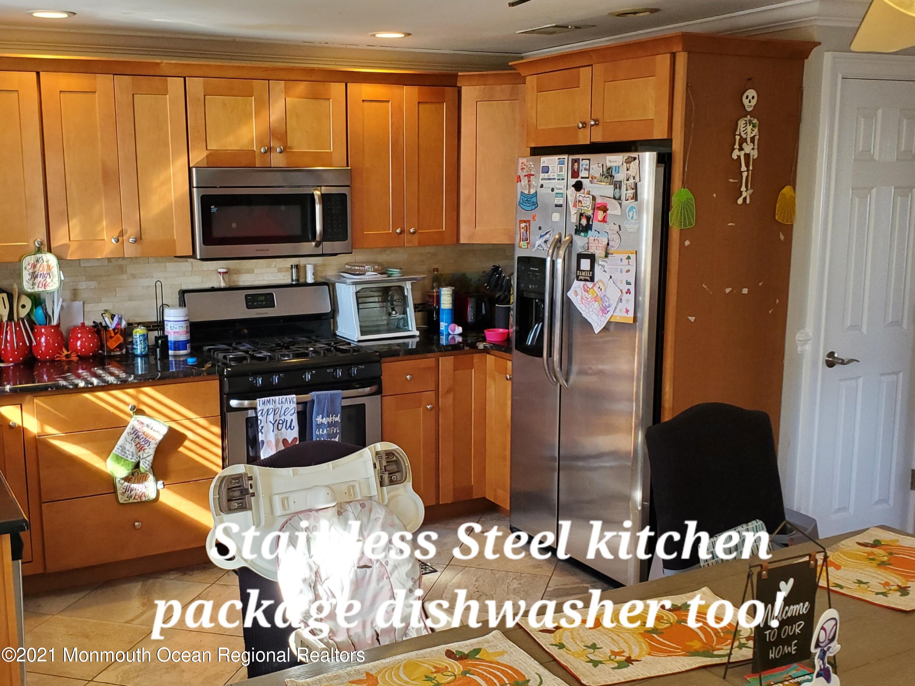 804 7th Street Union Beach, NJ 07735 - Photo 6 of 14 a kitchen with stainless steel appliances granite countertop a refrigerator stove and a sink