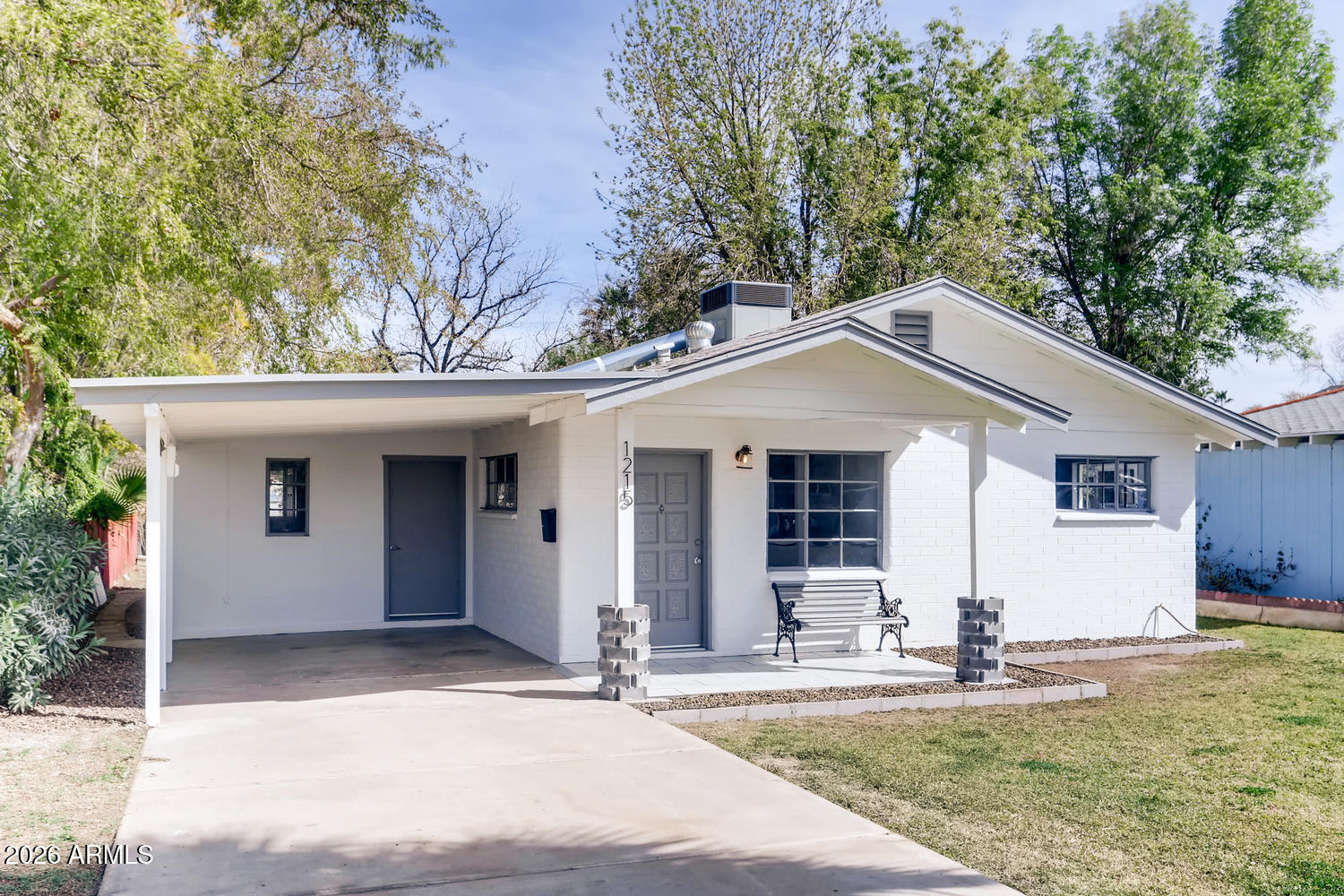 1215 South Judd Street Tempe, AZ 85281 - Photo 1 of 18 a front view of house with yard and trees in the background