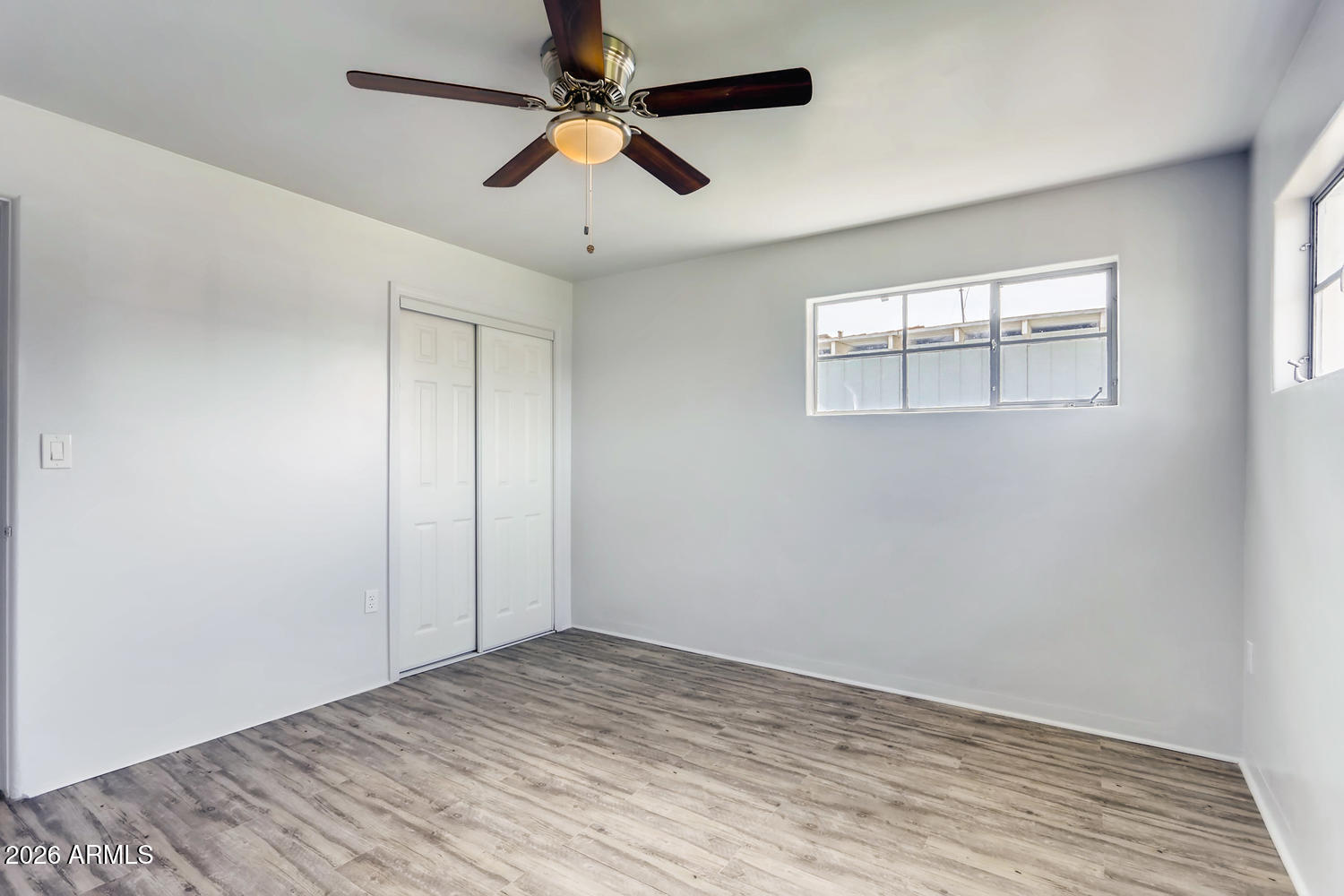 1215 South Judd Street Tempe, AZ 85281 - Photo 12 of 18 wooden floor in an empty room with a window