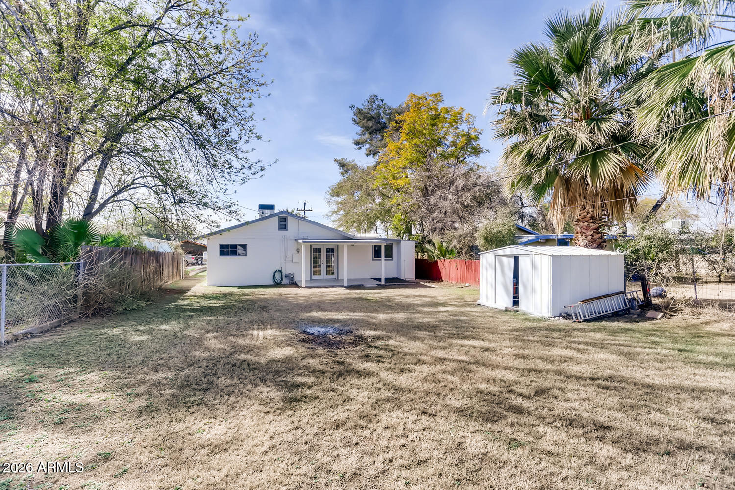 1215 South Judd Street Tempe, AZ 85281 - Photo 15 of 18 a white house that has a tree in front of it