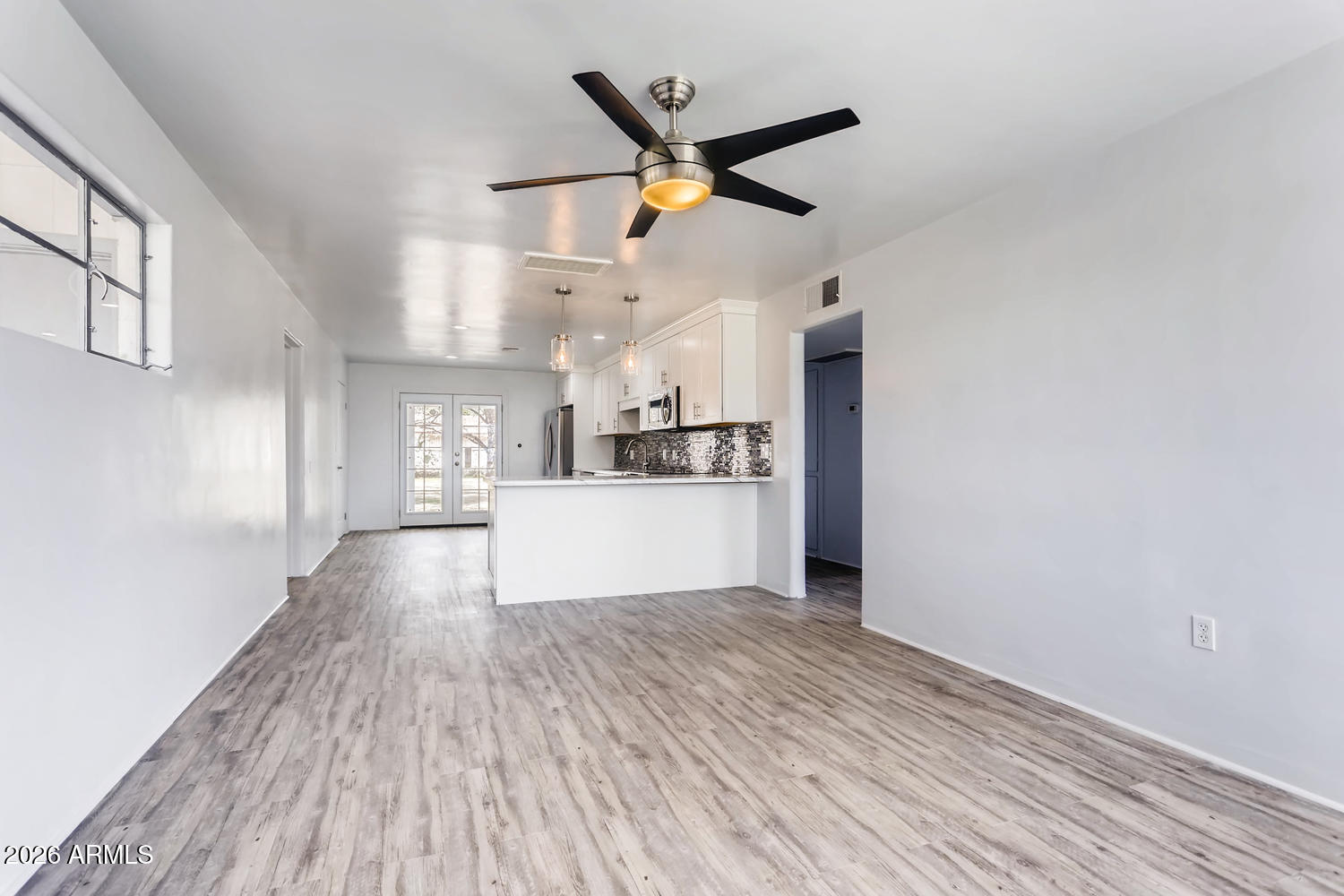 1215 South Judd Street Tempe, AZ 85281 - Photo 5 of 18 a view of a kitchen with wooden floor a ceiling fan and wooden floor