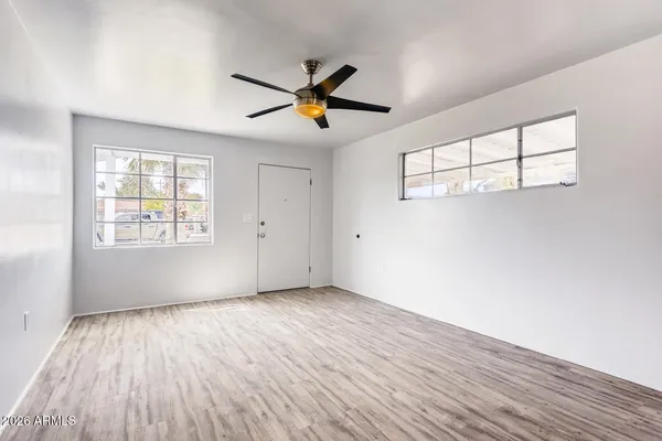 wooden floor in an empty room with a window