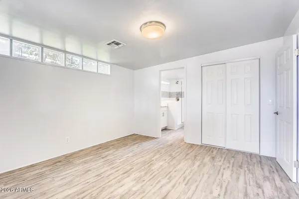 a view of empty room with wooden floor