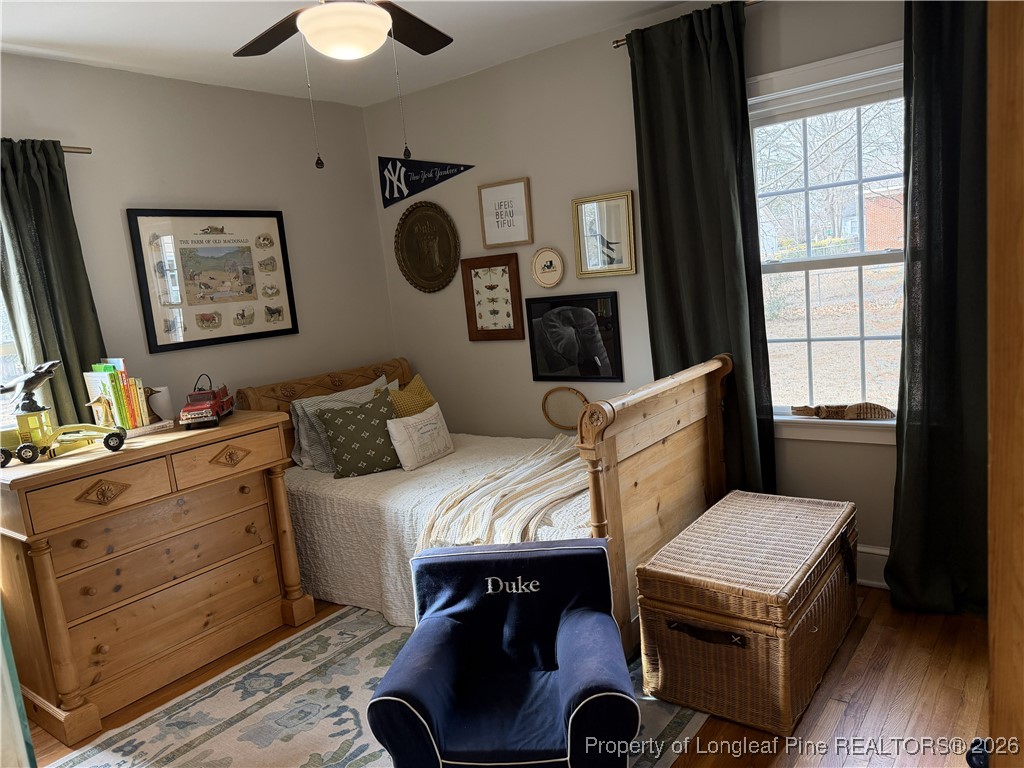 211 North Dickson Street Raeford, NC 28376 - Photo 11 of 14 a bedroom with a bed and wooden floor