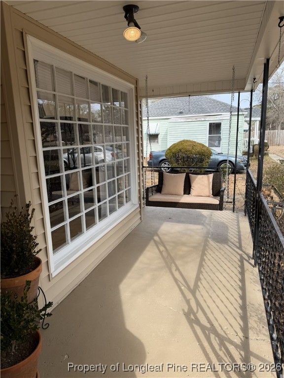 211 North Dickson Street Raeford, NC 28376 - Photo 4 of 14 a view of a balcony with a potted plant and floor to ceiling window