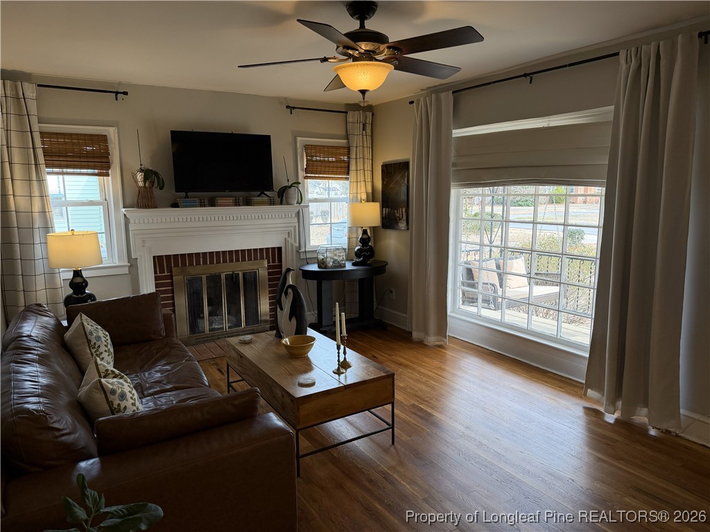 211 North Dickson Street Raeford, NC 28376 - Photo 7 of 14 a living room with furniture a flat screen tv and a fireplace