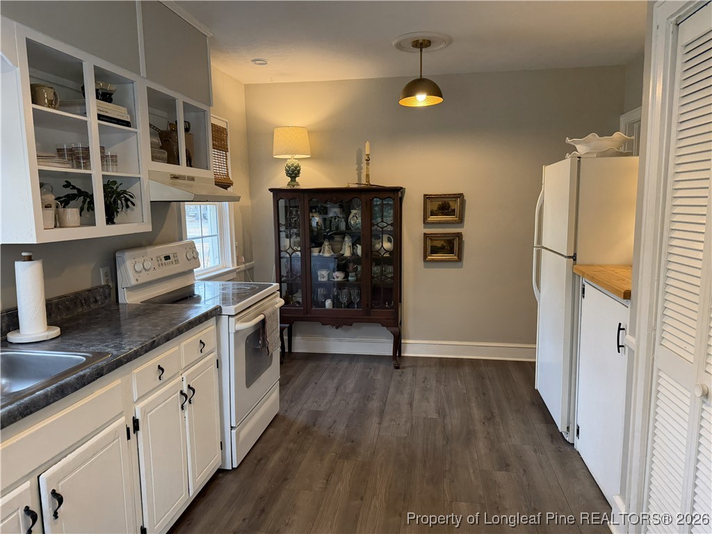 211 North Dickson Street Raeford, NC 28376 - Photo 9 of 14 a kitchen with stainless steel appliances granite countertop a refrigerator a stove and a wooden floors