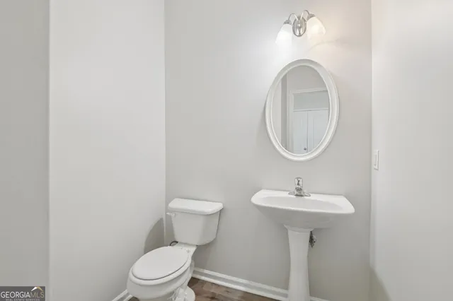 a bathroom with a sink a mirror and toilet