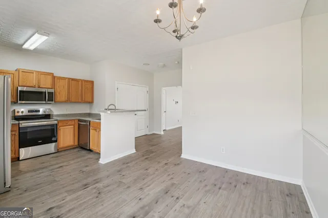 a kitchen with a refrigerator and a stove top oven
