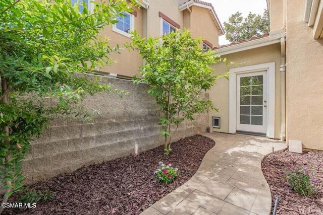 a view of a chair and fire pit in front of a building