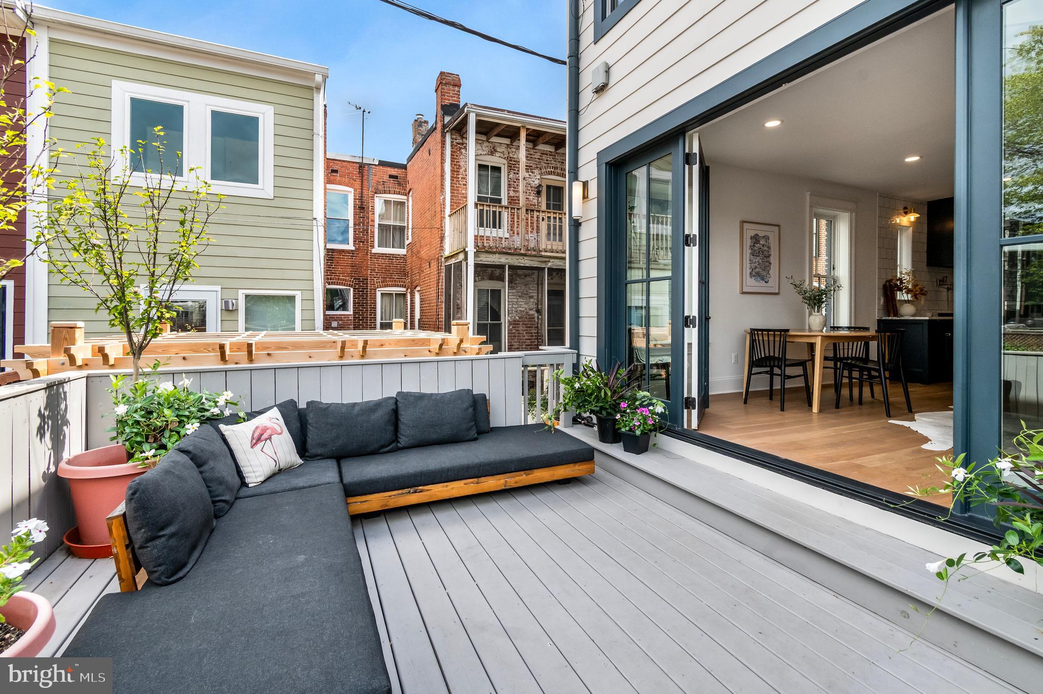 326 D Street Northeast Washington, DC 20002 - Photo 18 of 53 a view of a patio with couches chairs and potted plants with wooden floor