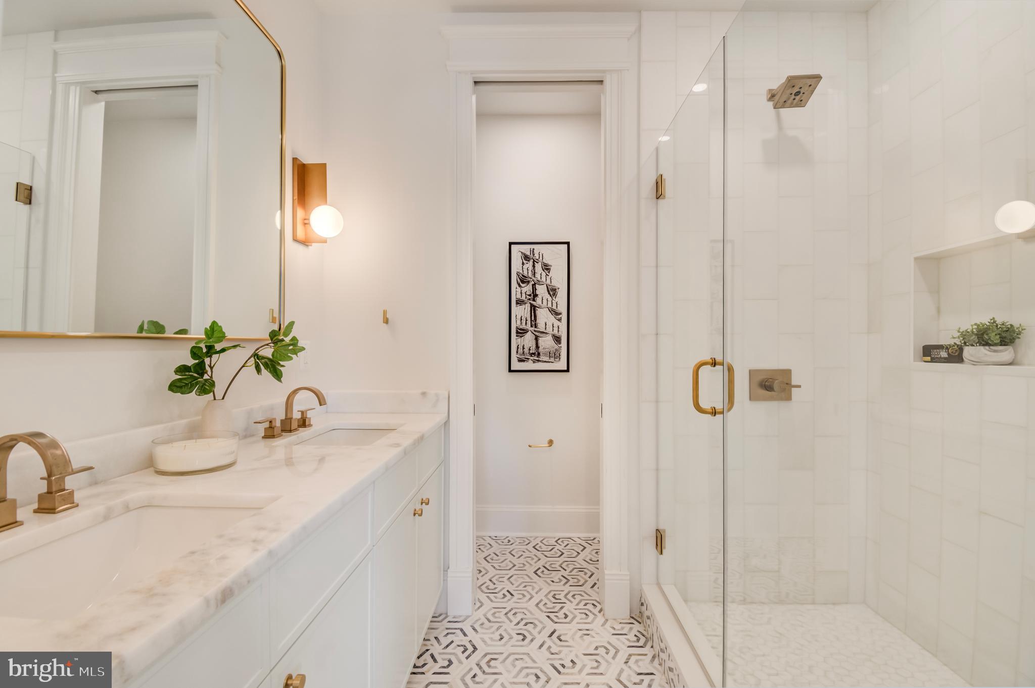 326 D Street Northeast Washington, DC 20002 - Photo 24 of 53 a bathroom with a granite countertop sink a mirror and shower