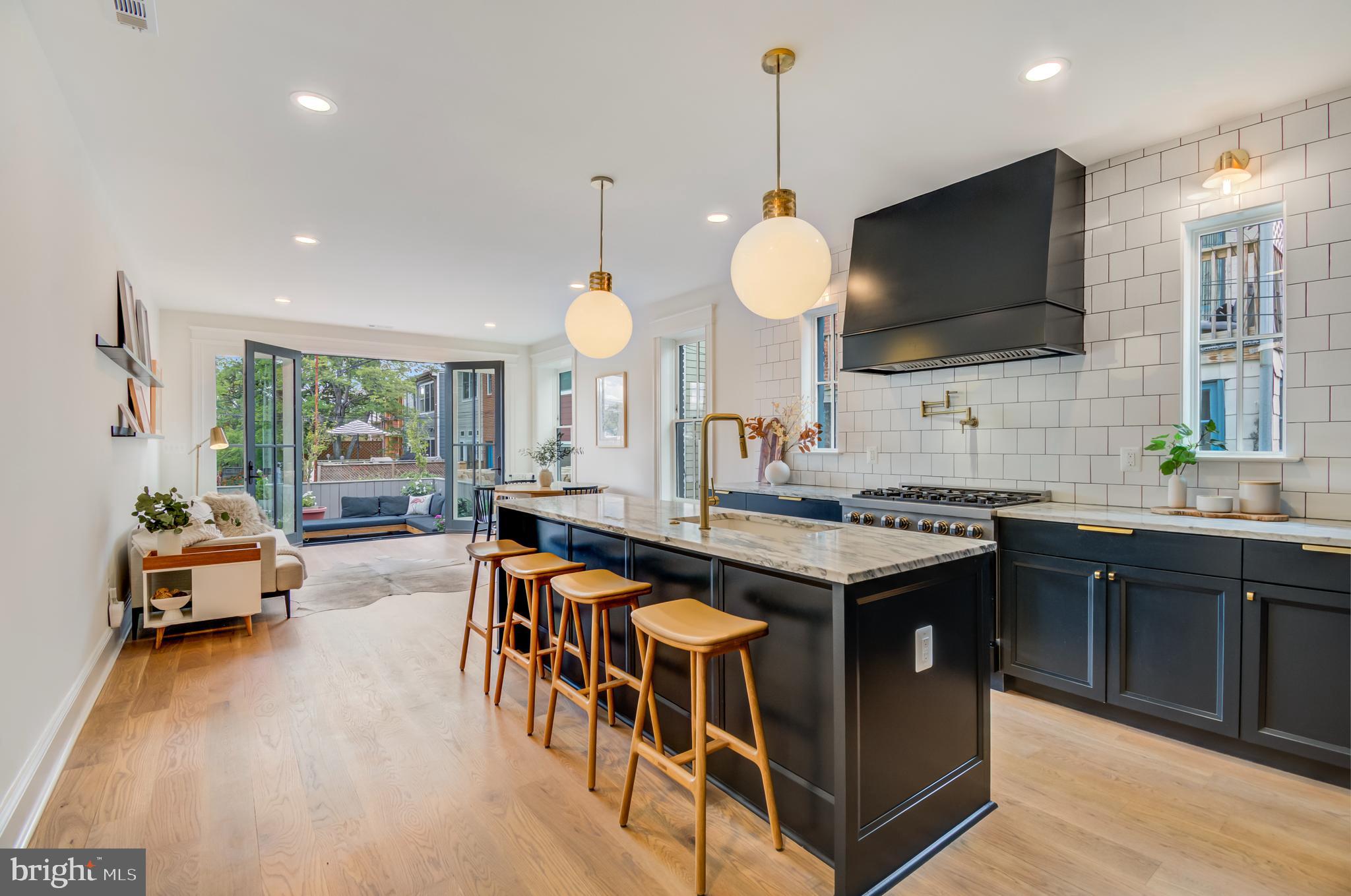 326 D Street Northeast Washington, DC 20002 - Photo 49 of 53 a kitchen with stainless steel appliances granite countertop a stove and a sink