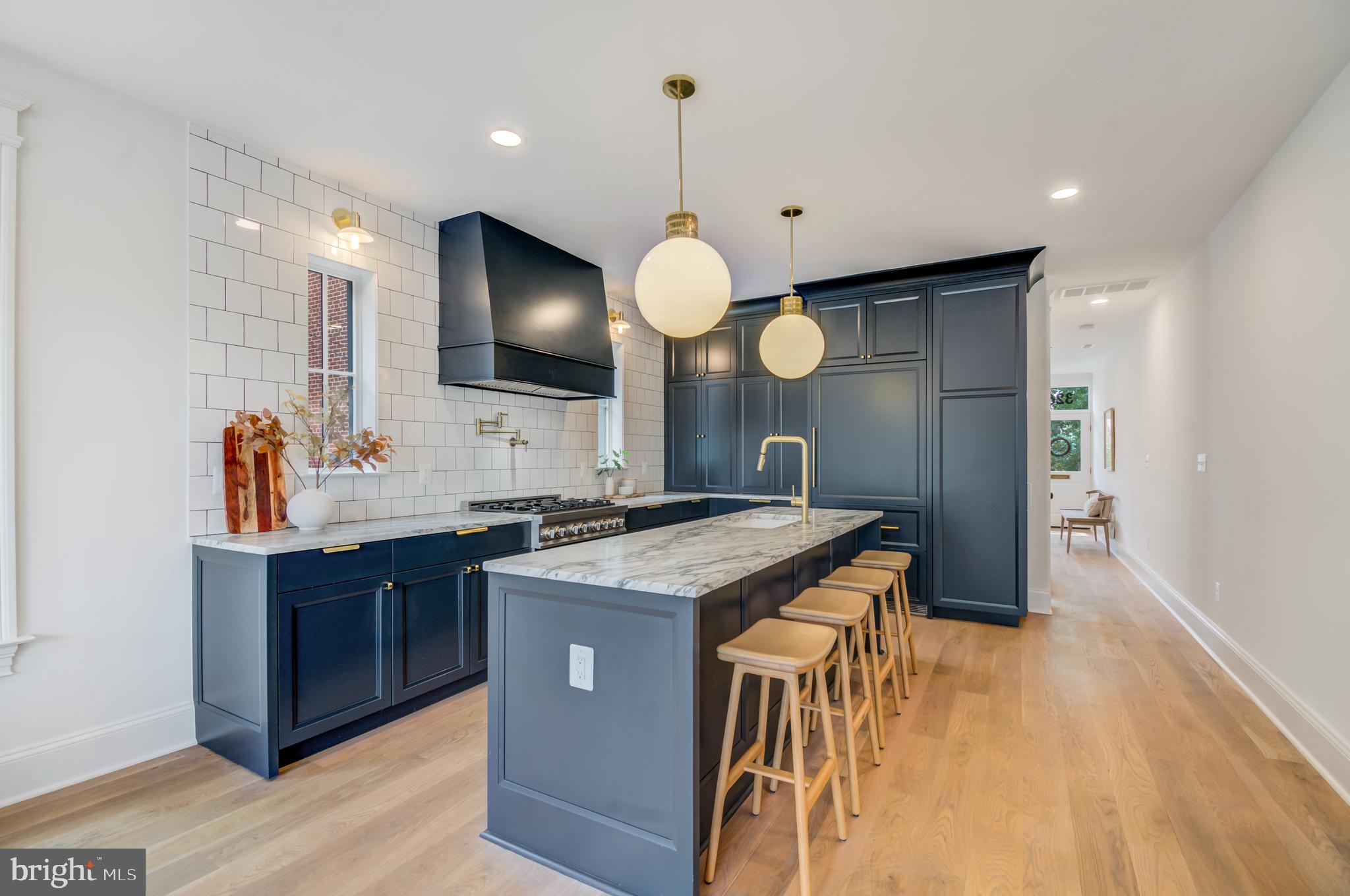 326 D Street Northeast Washington, DC 20002 - Photo 9 of 53 a kitchen with a sink a counter space and a view of living room