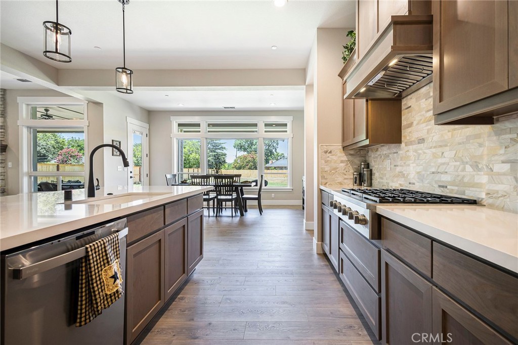 3 Haystack Court Chico, CA 95973 - Photo 21 of 75 a kitchen with stainless steel appliances granite countertop a sink stove and refrigerator