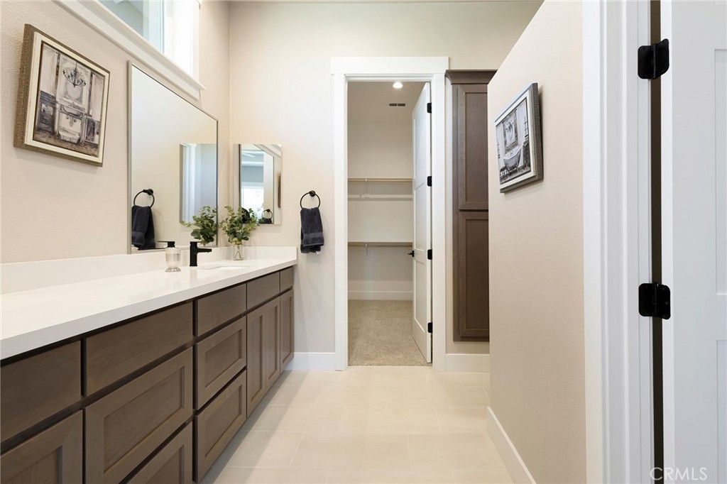 3 Haystack Court Chico, CA 95973 - Photo 31 of 75 a bathroom with a double vanity sink a mirror and a shower