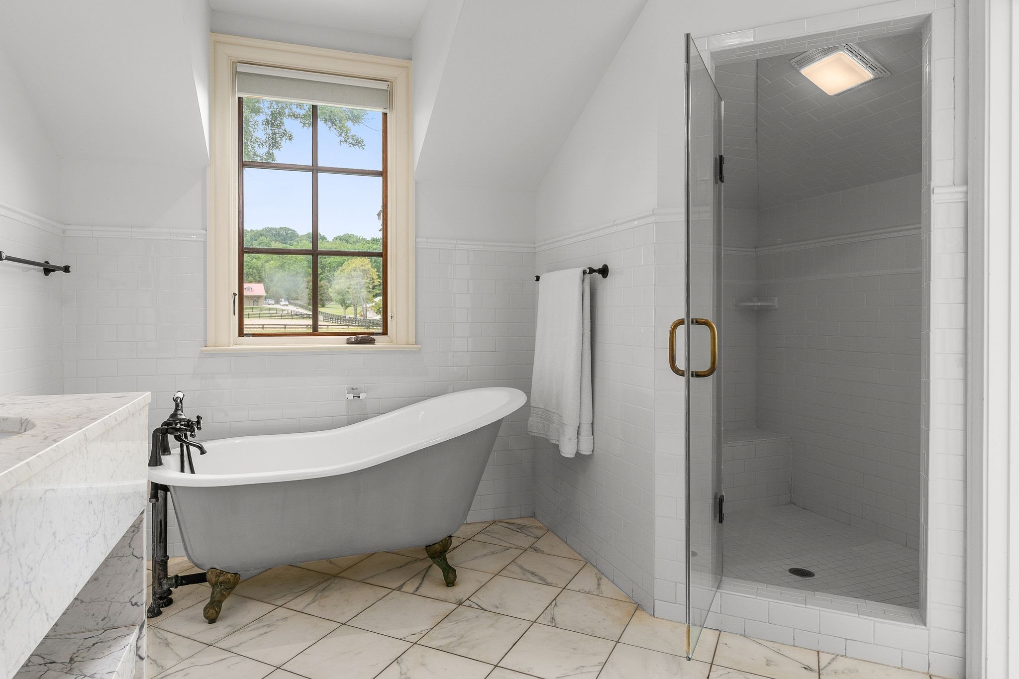 222 Arrowhead Road Franklin, TN 37069 - Photo 18 of 55 a bathroom with a tub a shower and a window