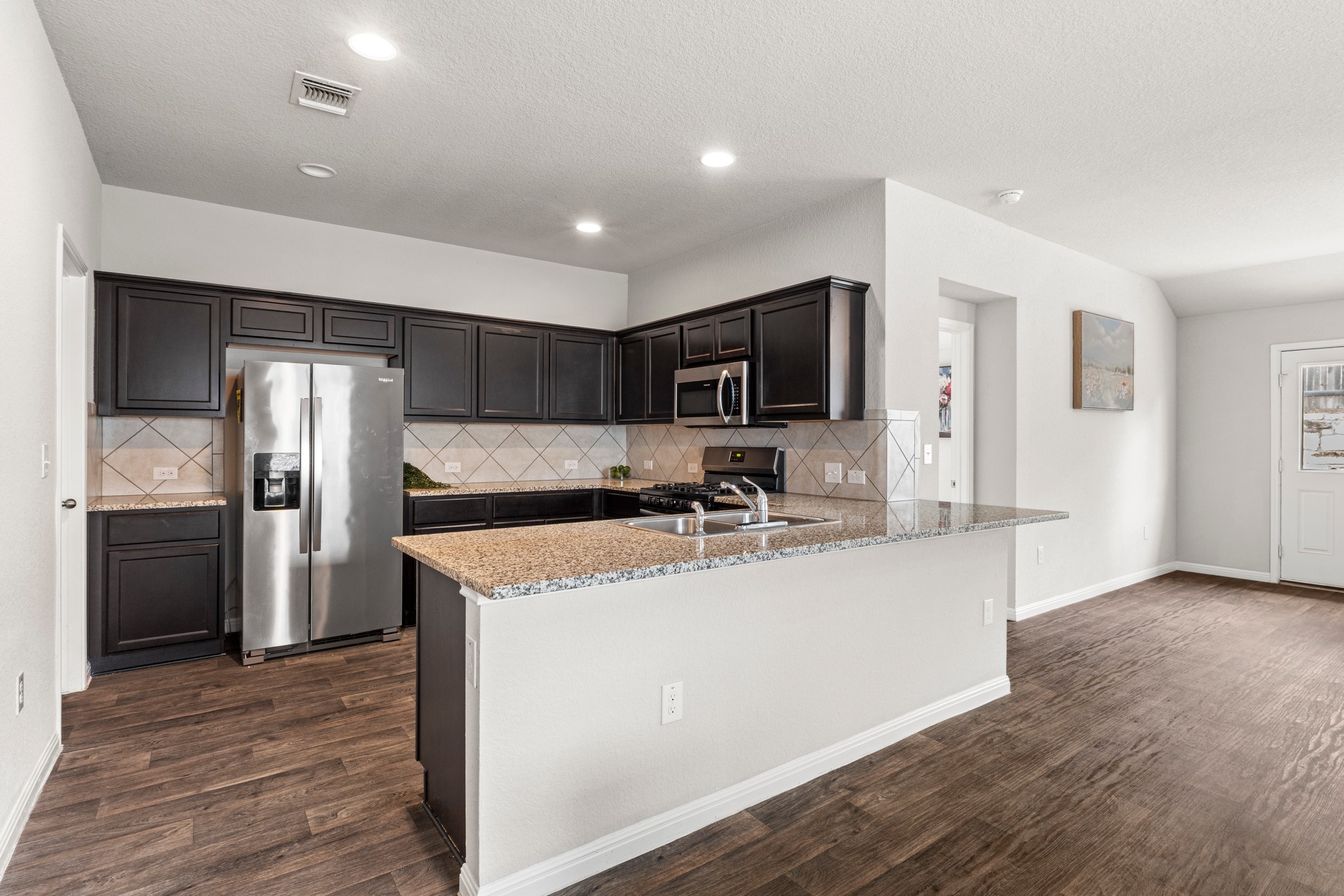 10809 Gonzales Ranger Pass Austin, TX 78754 - Photo 13 of 37 The kitchen is designed for ease of use and comes wrapped in rich cabinetry for all your storage needs.