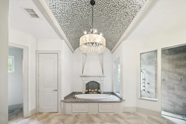 a bathroom with a granite countertop double vanity sink and a mirror