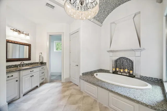 a kitchen with granite countertop white cabinets and a window
