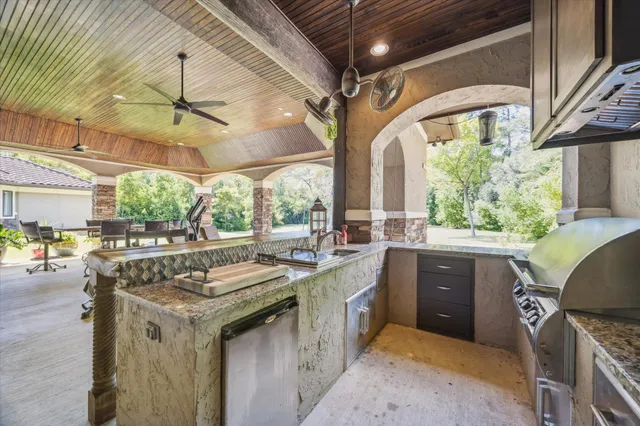 a front view of a house with a yard and trees