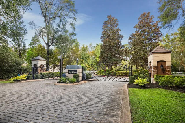 a front view of a house with a garden and trees