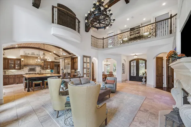 a living room with furniture a fireplace and potted plants
