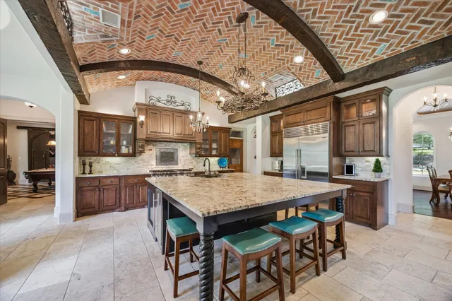 a kitchen with stainless steel appliances granite countertop a sink stove and cabinets