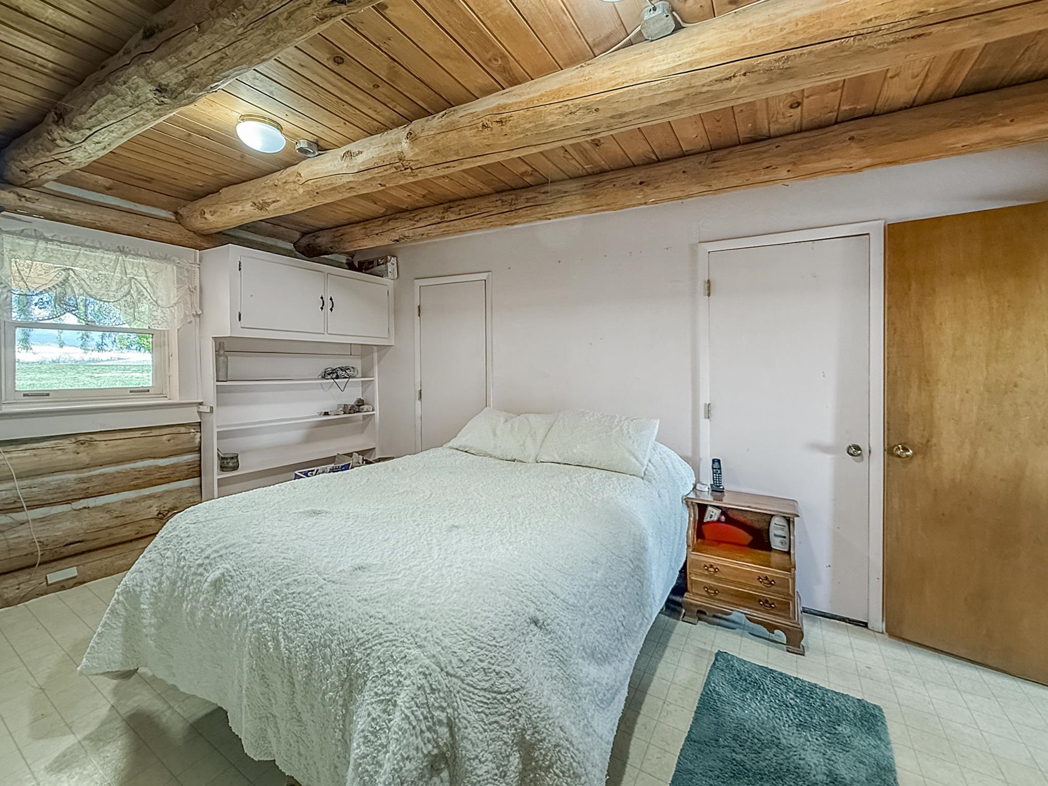 9709 3605 Road Hotchkiss, CO 81419 - Photo 18 of 42 a bed sitting in a bedroom next to a window