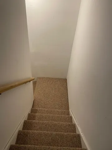 a room with gym equipment and a view of living room