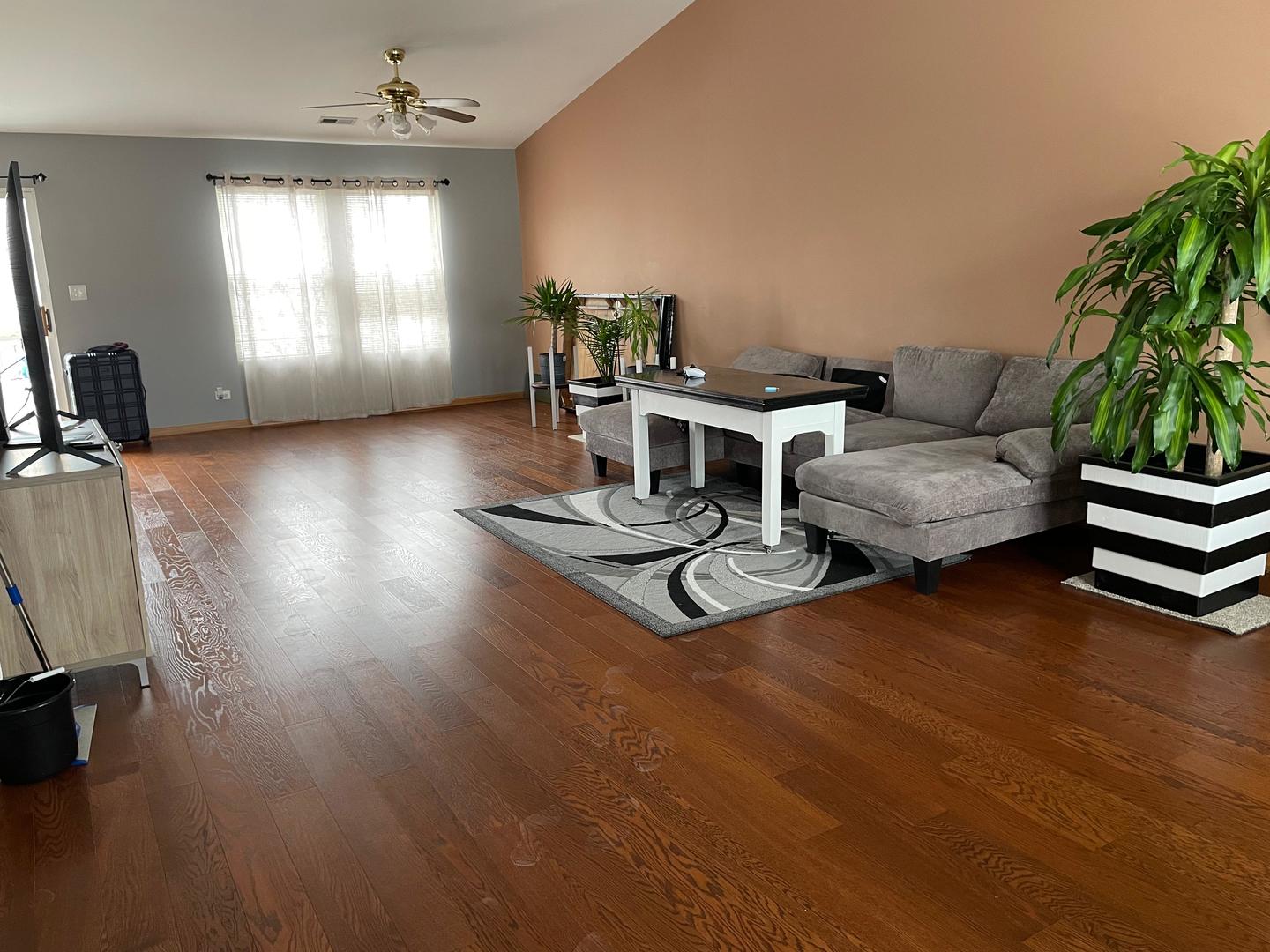2497 Reflections Drive Aurora, IL 60502 - Photo 2 of 22 a living room with furniture and a chandelier