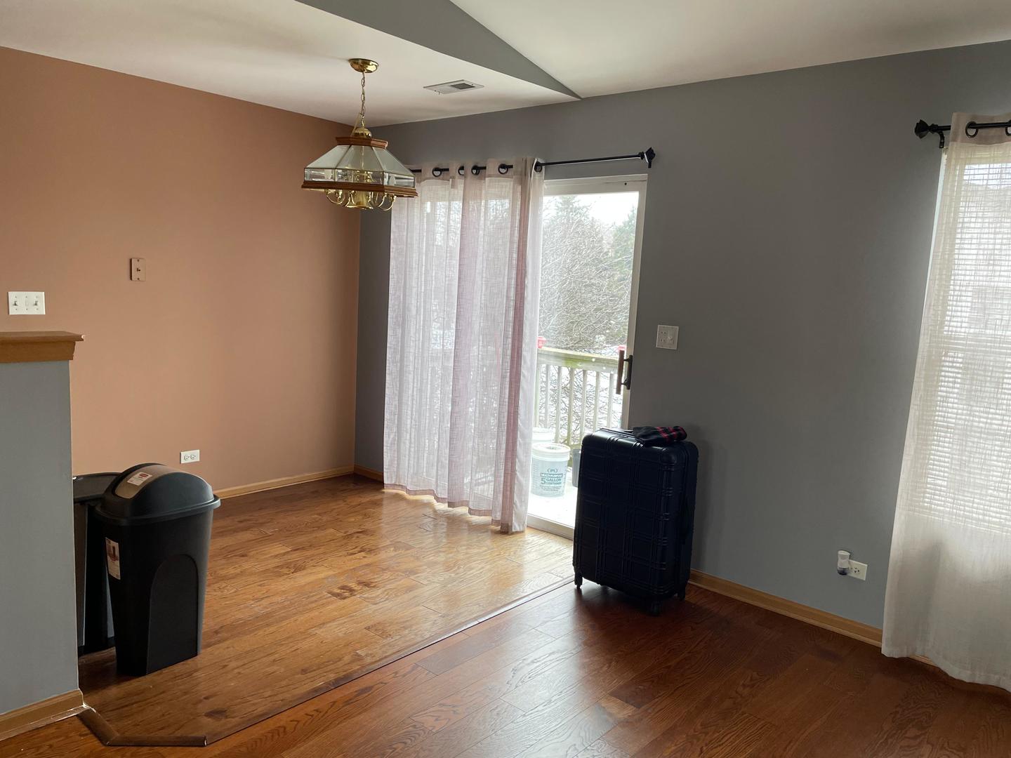 2497 Reflections Drive Aurora, IL 60502 - Photo 4 of 22 an empty room with wooden floor and windows