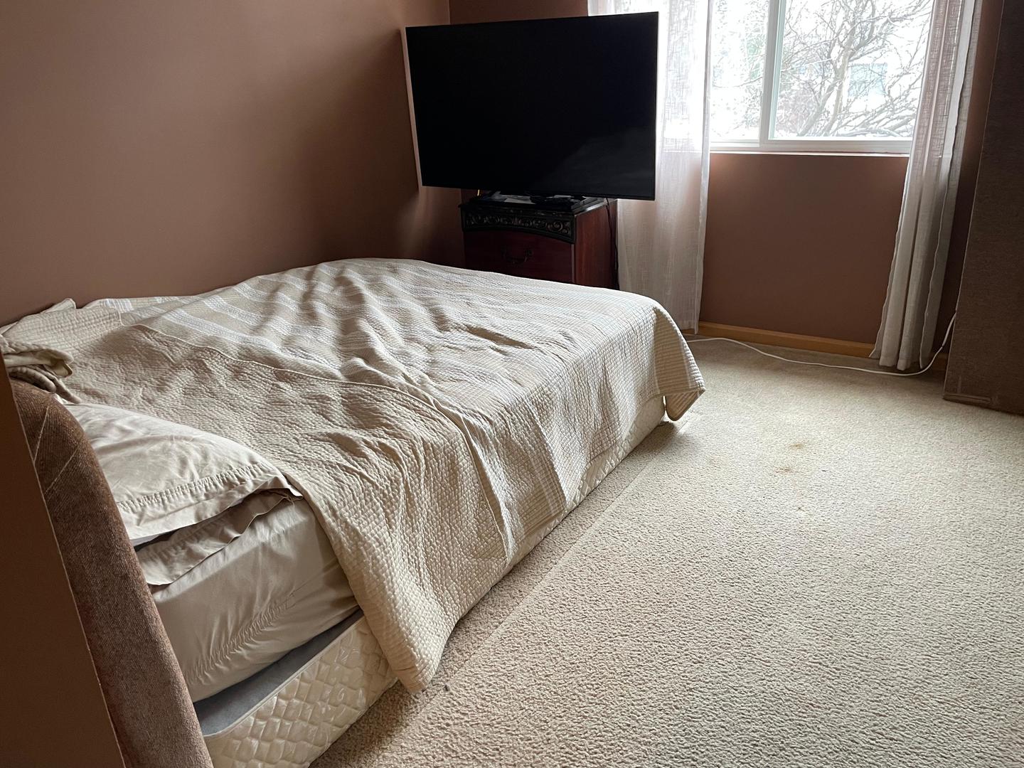 2497 Reflections Drive Aurora, IL 60502 - Photo 10 of 22 a bedroom with a bed and flat tv screen on the dresser