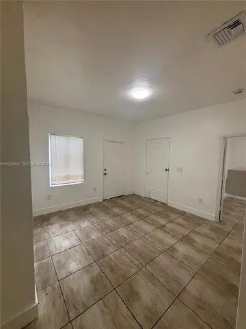 a view of a hallway to rooms